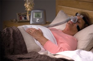 Merits and Demerits of CPAP Machines woman sleeping with CPAP machine