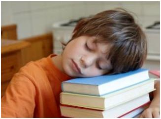 A child sleeping in school due to the lack of sleep